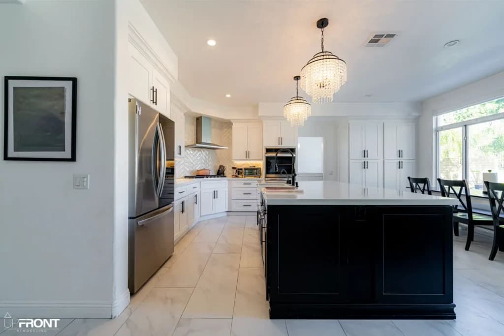 Black-and-white kitchen and bathroom remodel in Moorpark, with white shaker cabinetry and a black island — photo 1 of 18