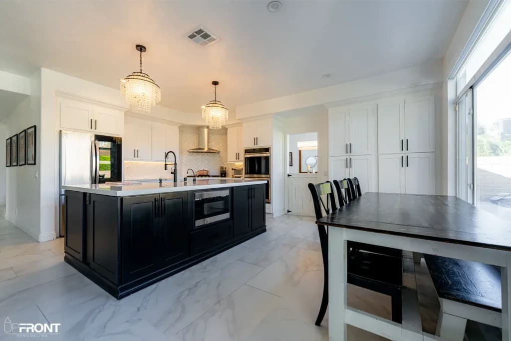 Black-and-white kitchen and bathroom remodel in Moorpark, with white shaker cabinetry and a black island — photo 2 of 18
