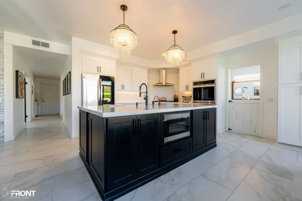 Black-and-white kitchen and bathroom remodel in Moorpark, with white shaker cabinetry and a black island — photo 3 of 18
