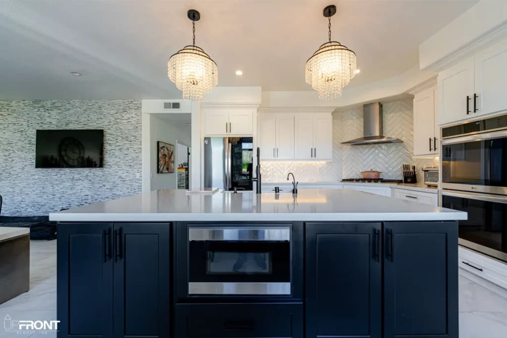 Black-and-white kitchen and bathroom remodel in Moorpark, with white shaker cabinetry and a black island — photo 4 of 18
