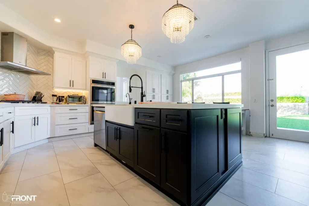Black-and-white kitchen and bathroom remodel in Moorpark, with white shaker cabinetry and a black island — photo 6 of 18