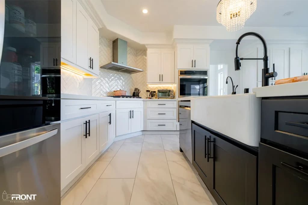 Black-and-white kitchen and bathroom remodel in Moorpark, with white shaker cabinetry and a black island — photo 7 of 18