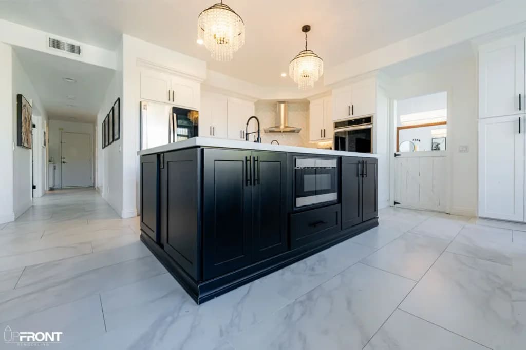 Black-and-white kitchen and bathroom remodel in Moorpark, with white shaker cabinetry and a black island — photo 8 of 18