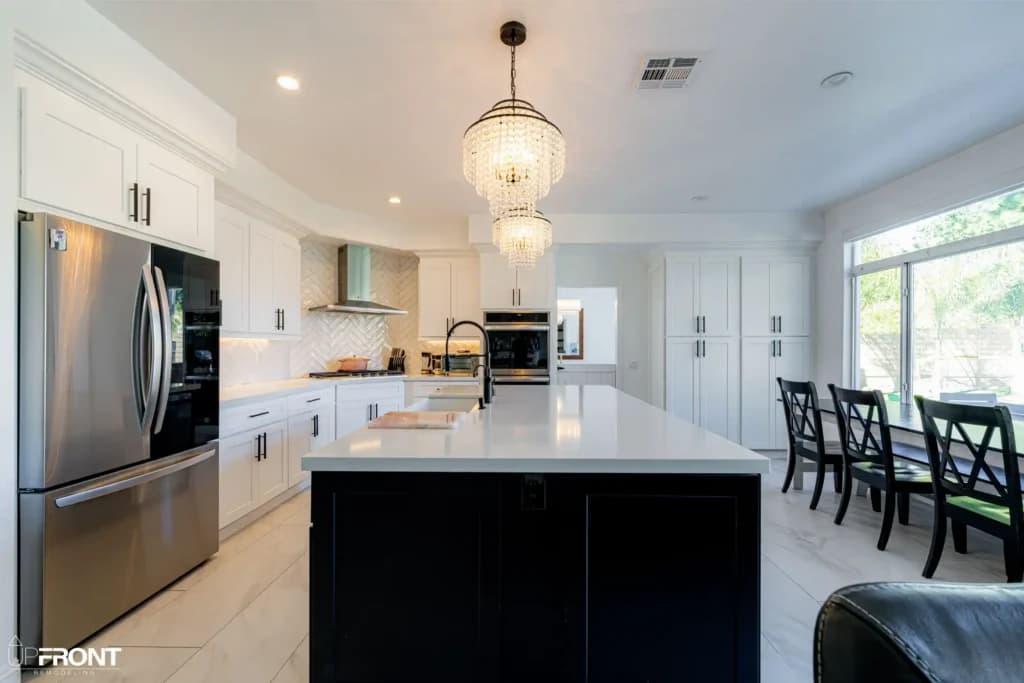 Black-and-white kitchen and bathroom remodel in Moorpark, with white shaker cabinetry and a black island — photo 10 of 18