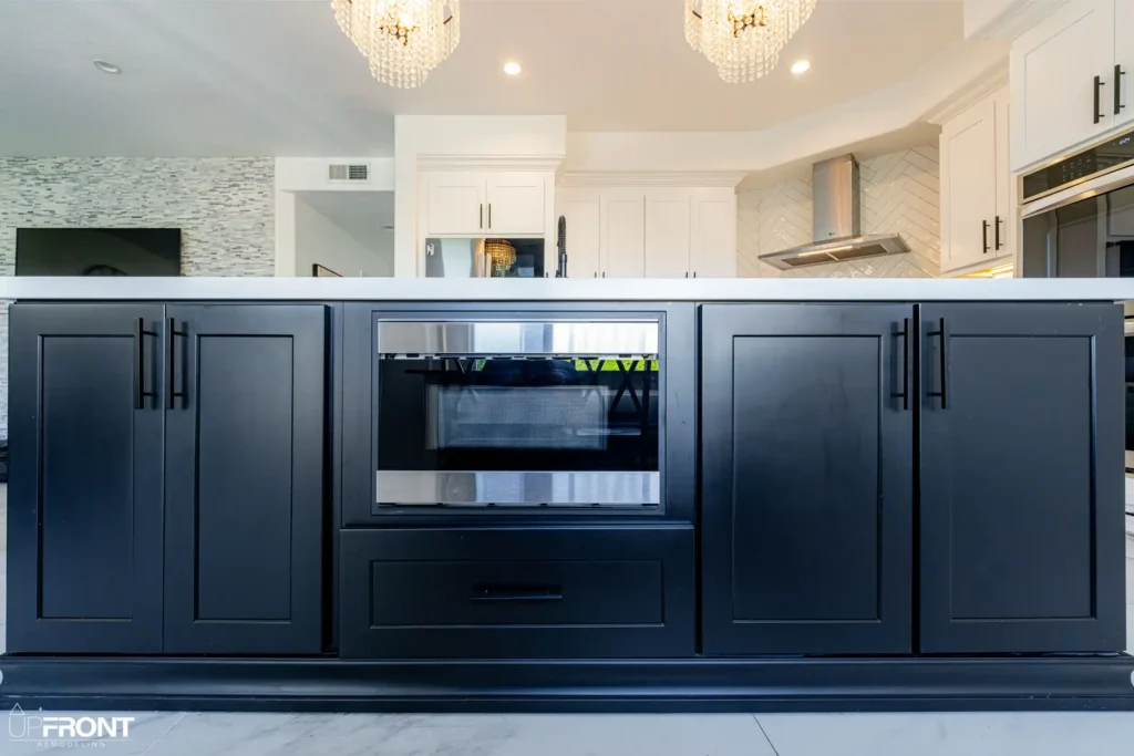 Black-and-white kitchen and bathroom remodel in Moorpark, with white shaker cabinetry and a black island — photo 11 of 18
