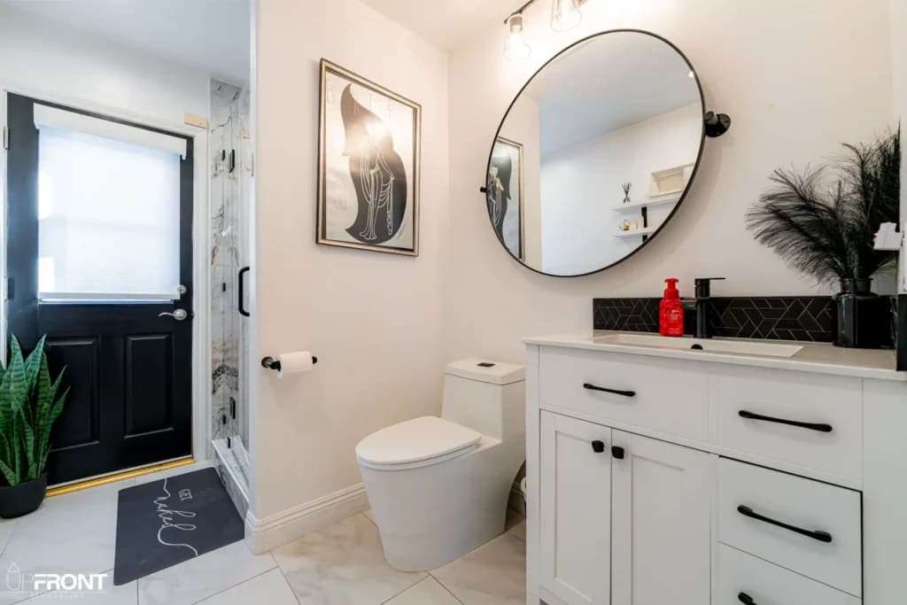Black-and-white kitchen and bathroom remodel in Moorpark, with white shaker cabinetry and a black island — photo 18 of 18