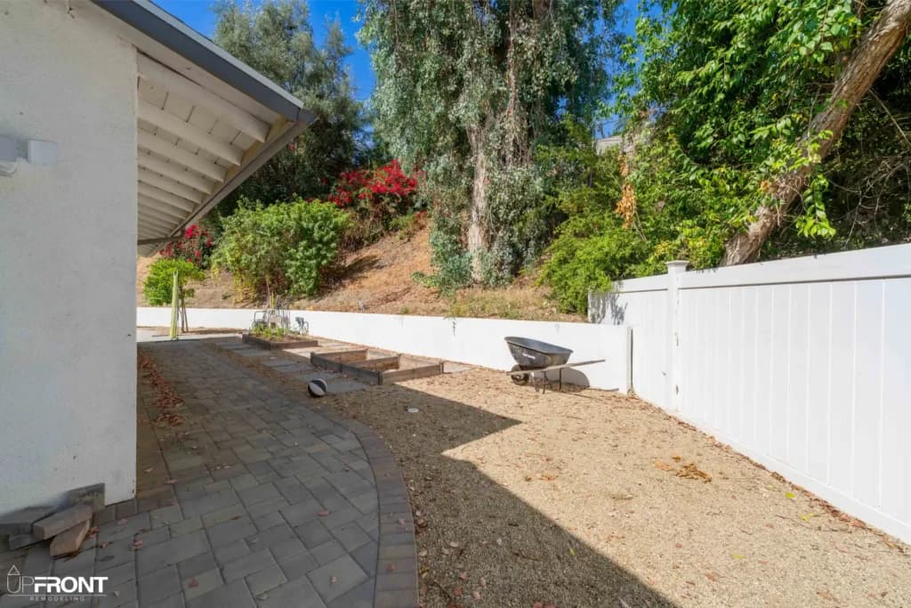 Resort-style backyard remodel in Tarzana, with a freeform pool, paver deck and louvered white pergola — photo 9 of 20