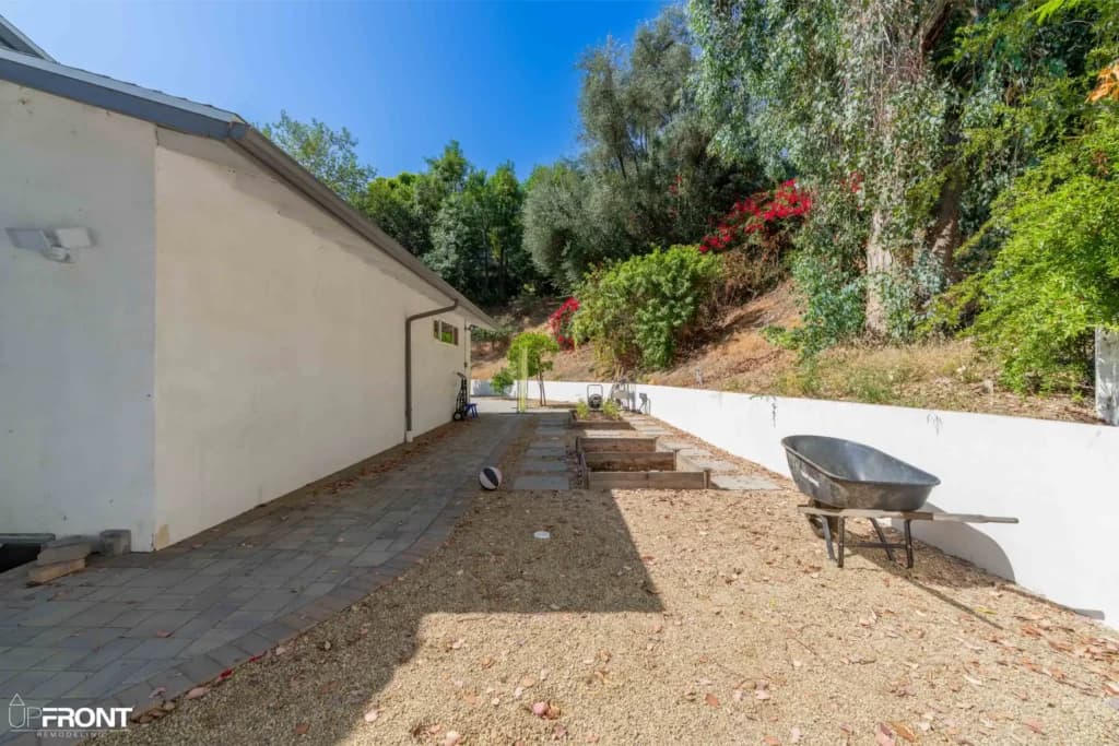 Resort-style backyard remodel in Tarzana, with a freeform pool, paver deck and louvered white pergola — photo 10 of 20