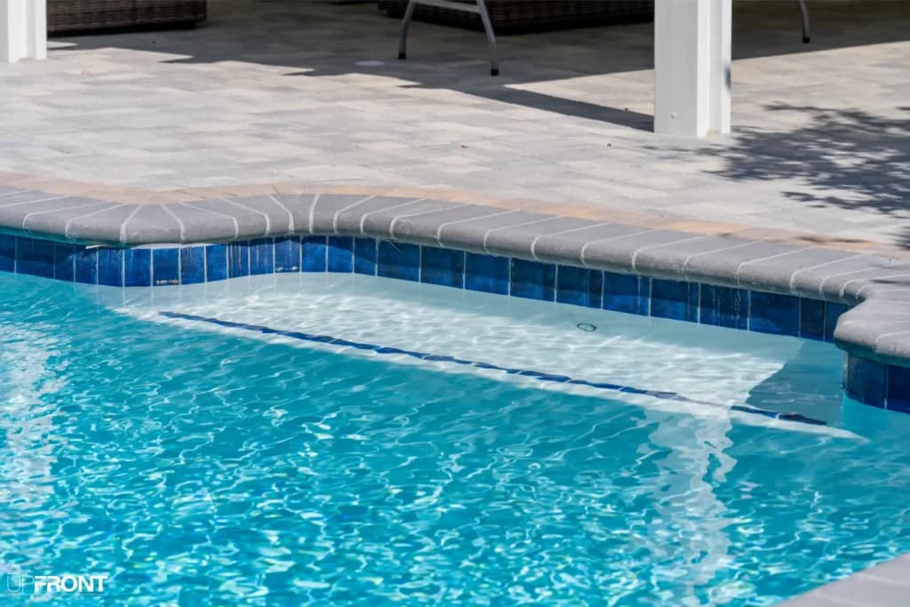 Resort-style backyard remodel in Tarzana, with a freeform pool, paver deck and louvered white pergola — photo 13 of 20