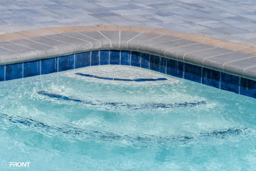 Resort-style backyard remodel in Tarzana, with a freeform pool, paver deck and louvered white pergola — photo 14 of 20