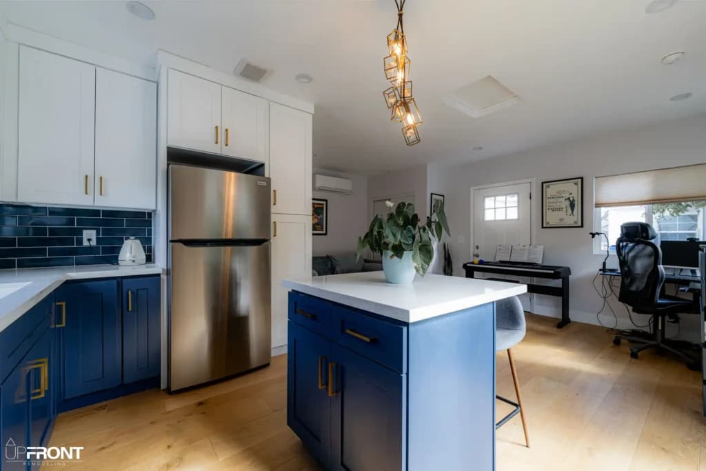 Garage converted into a self-contained ADU in Valley Village, with navy shaker cabinetry and quartz counters — photo 4 of 13