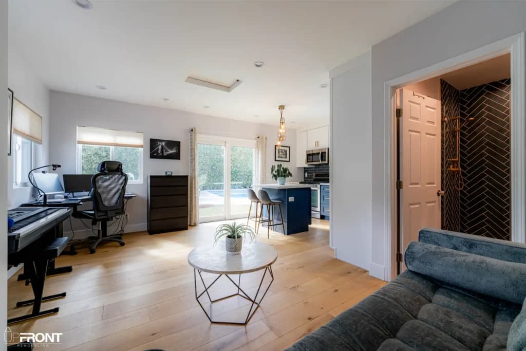 Garage converted into a self-contained ADU in Valley Village, with navy shaker cabinetry and quartz counters — photo 7 of 13