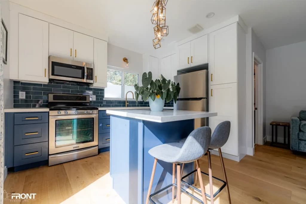 Garage converted into a self-contained ADU in Valley Village, with navy shaker cabinetry and quartz counters — photo 11 of 13