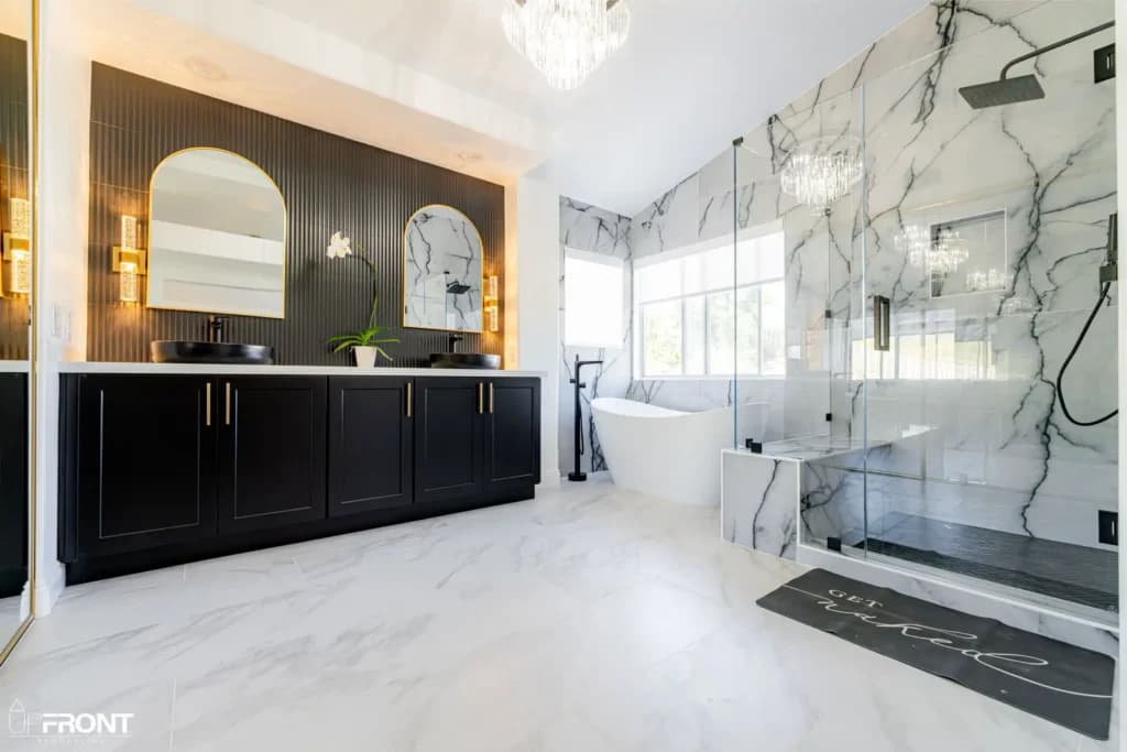 Master and kids' bathroom remodel in Moorpark, with Calacatta marble-look porcelain and a matte black vanity — photo 1 of 8